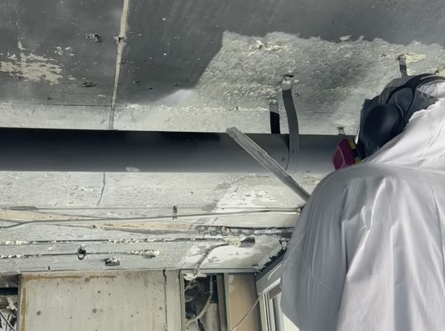 Removing sprayed-on foam insulation from the ceiling of a commercial building in Birmingham, MI